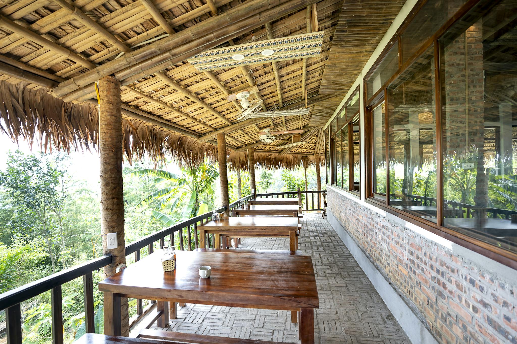 A rustic veranda with wooden furniture and nature views, perfect for relaxation.