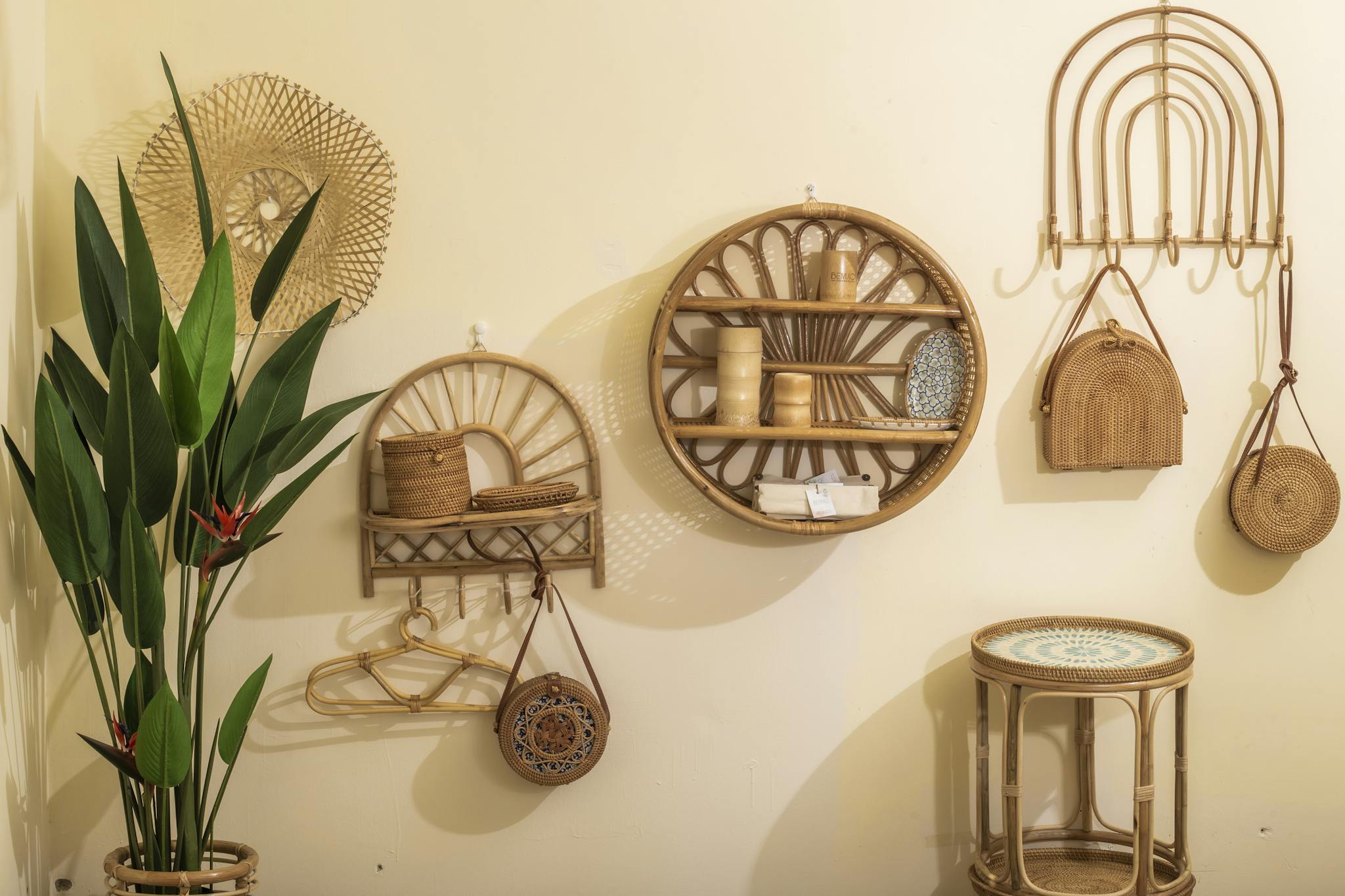 Stylish bamboo wall decor and plant in a neutral-toned living room, creating a warm atmosphere.